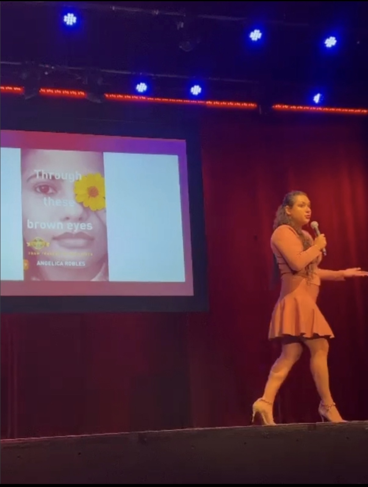 Angelica Robles presenting her book on stage