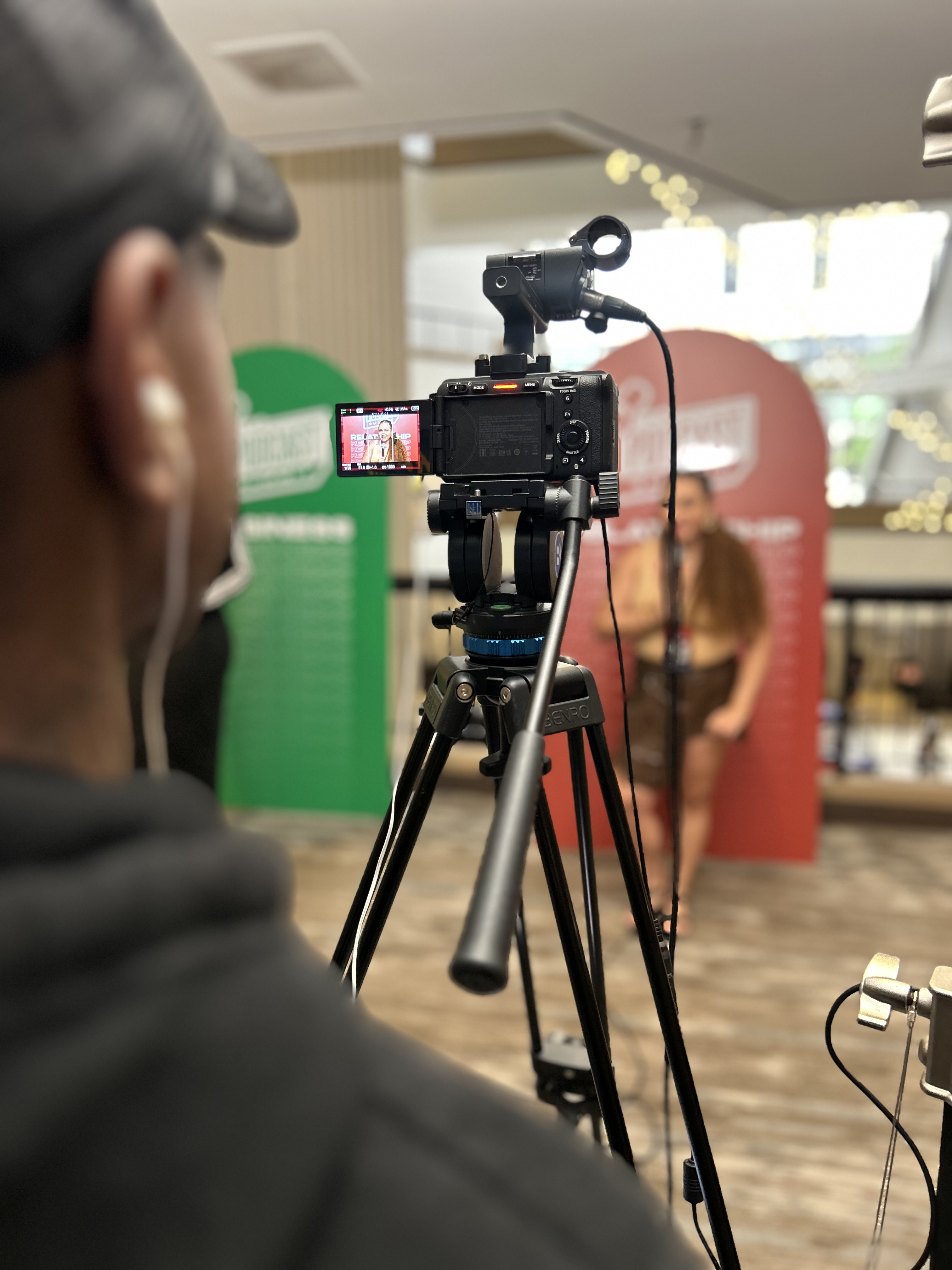 Camera operator filming Angelica Robles at an event