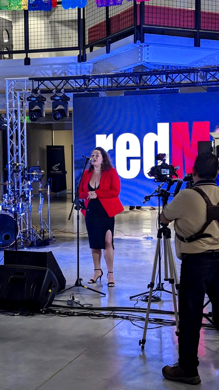 Angelica Robles performing on stage with a microphone