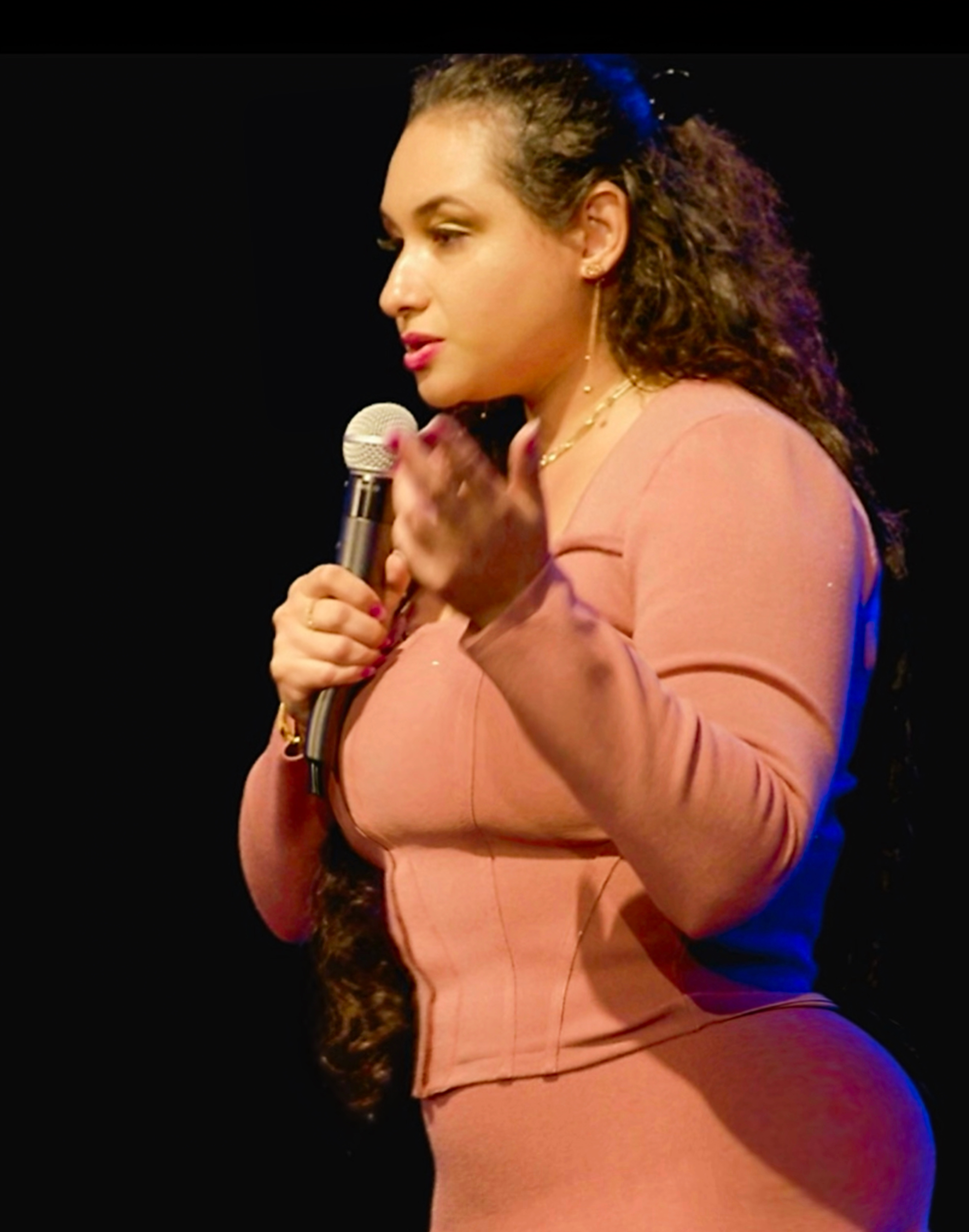 Angelica Robles speaking on stage with a microphone